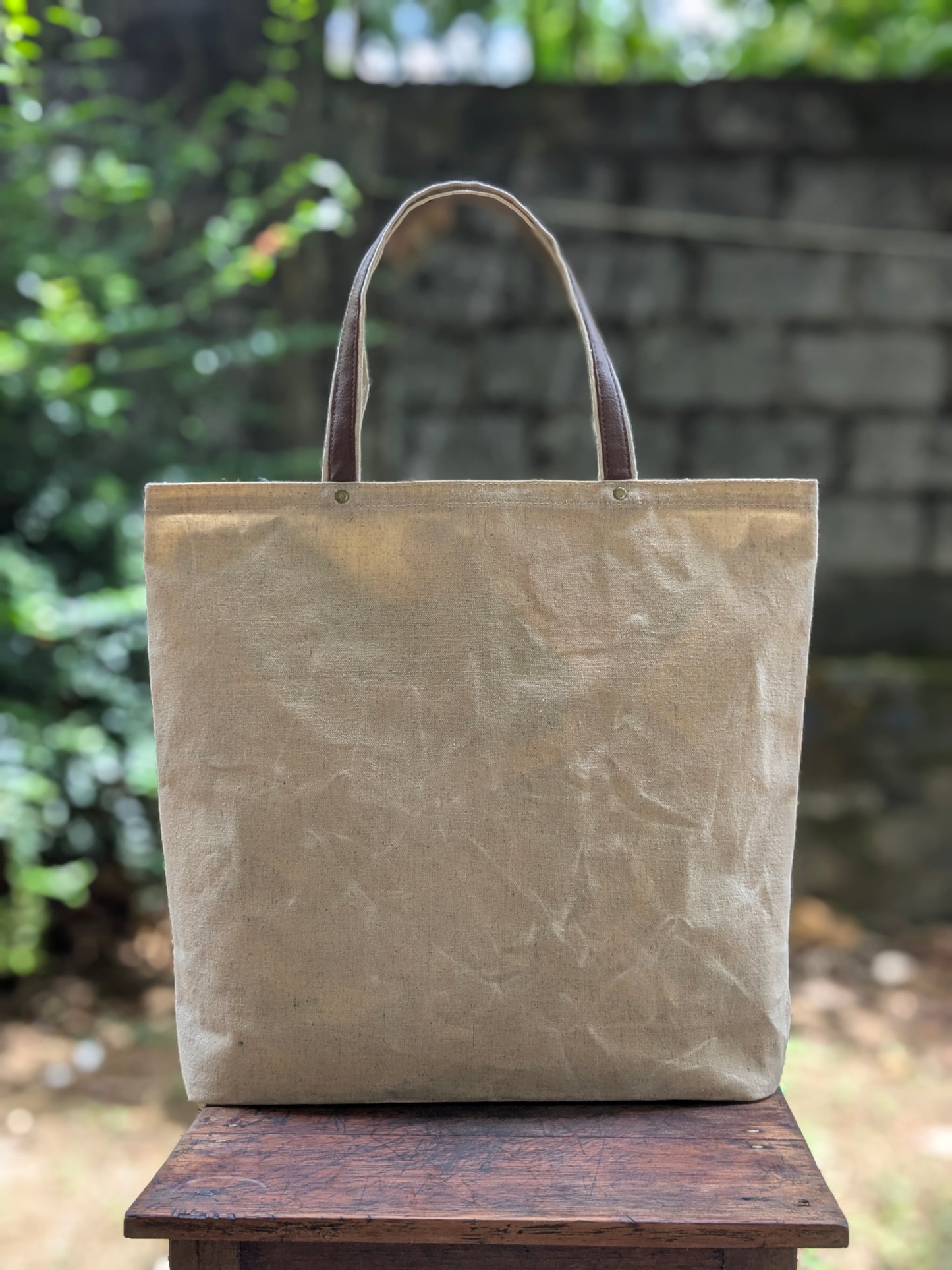 LadyMady Handmade Waxed Canvas Tote Bag with Selectable Aromas in a natural color on a wooden surface.
