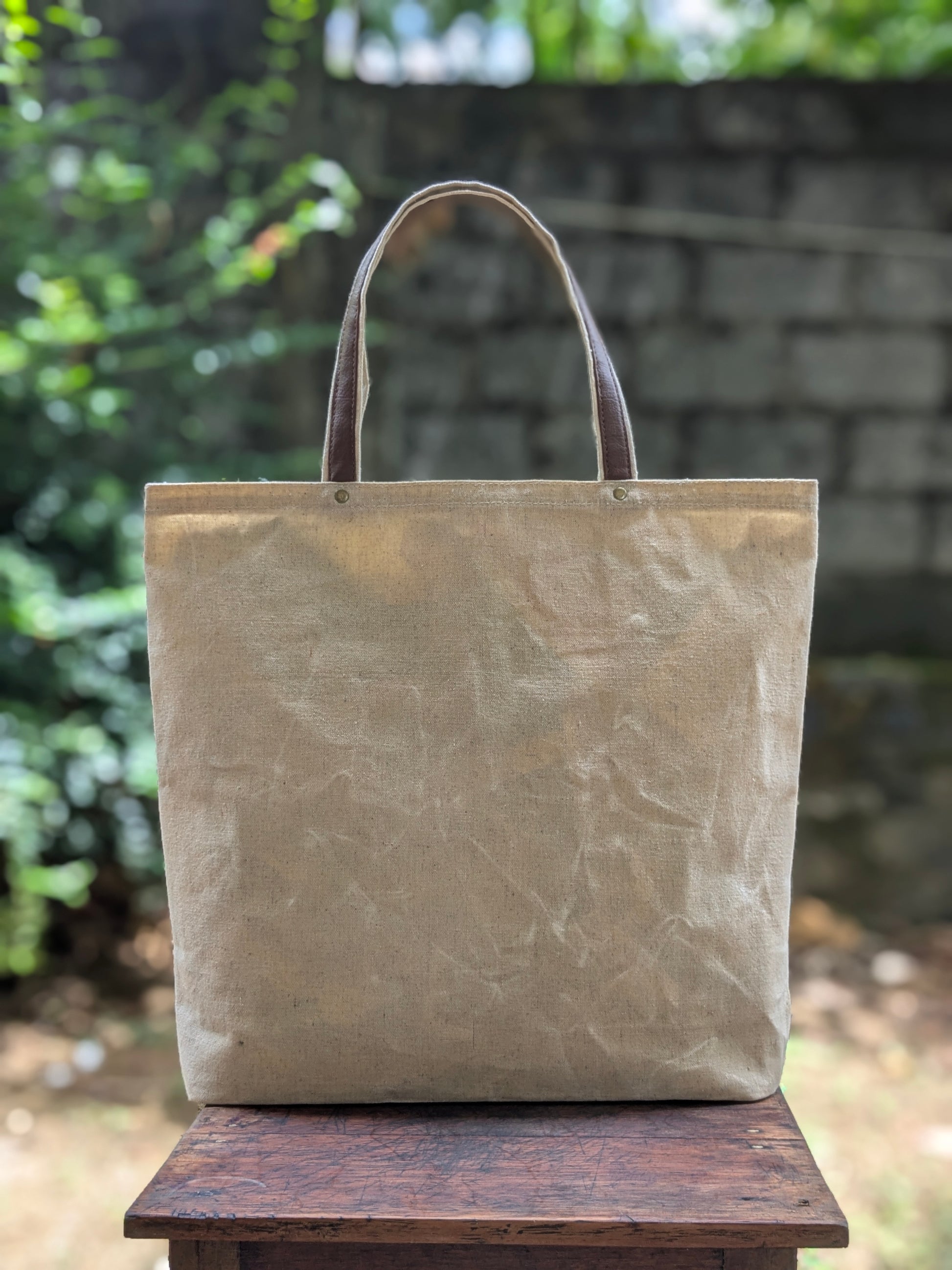 LadyMady Handmade Waxed Canvas Tote Bag with Selectable Aromas in a natural color on a wooden surface.