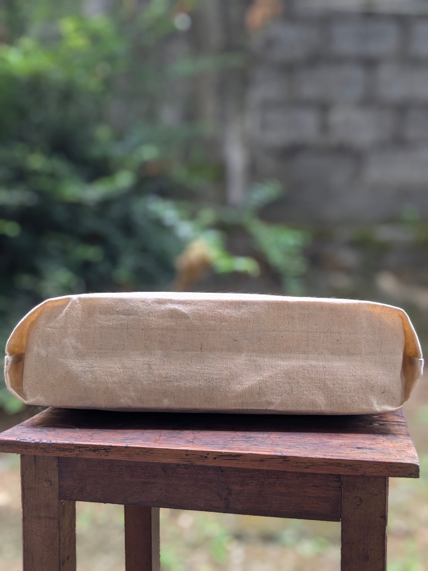LadyMady Handmade Waxed Canvas Tote Bag showcasing its sturdy design on a wooden table.