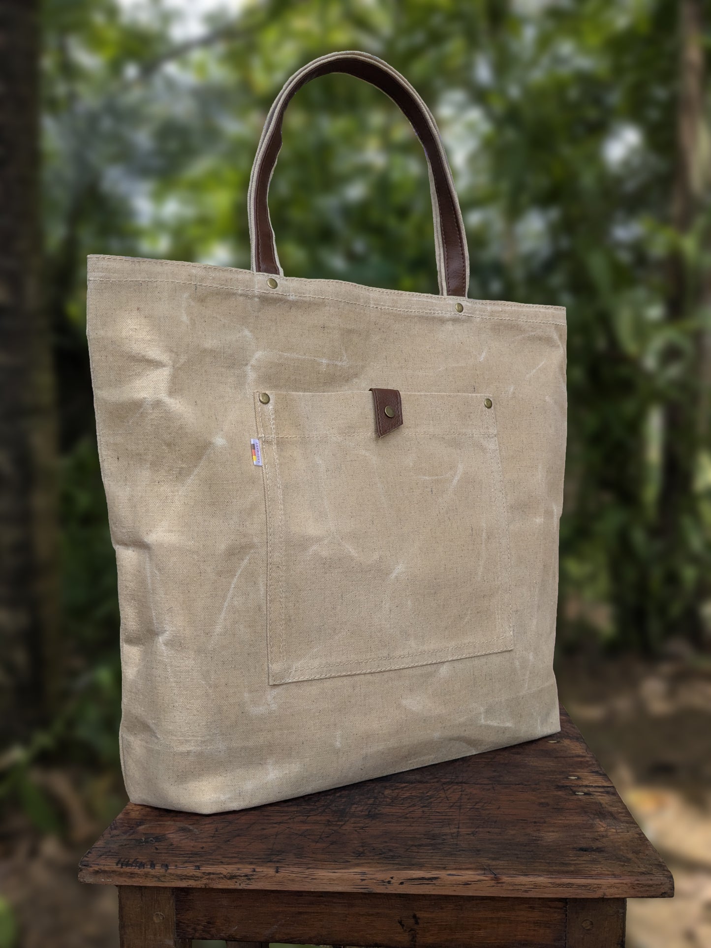 LadyMady waxed canvas tote bag showcasing durable design and stylish leather handles, perfect for everyday use.