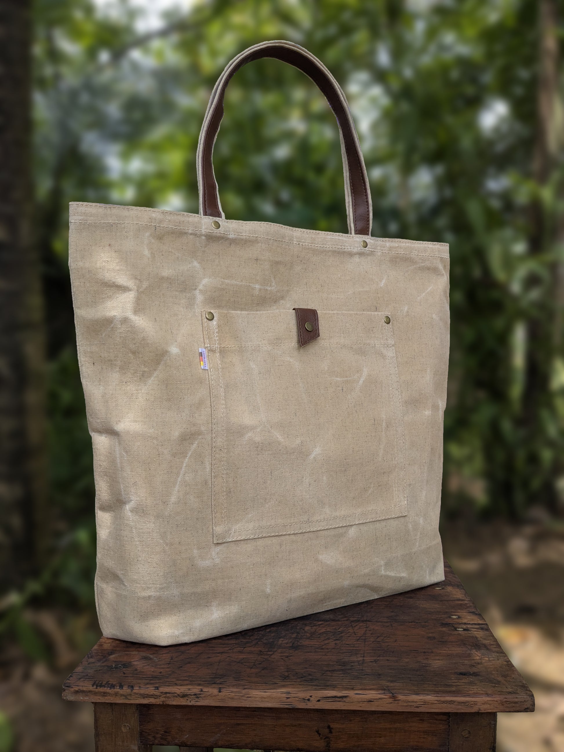 LadyMady waxed canvas tote bag showcasing durable design and stylish leather handles, perfect for everyday use.